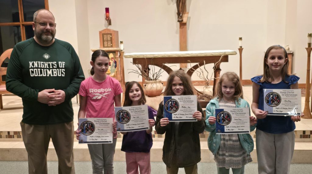 Knights of Columbus member standing with five children recognized in the Keep Christ in Christmas Poster Contest